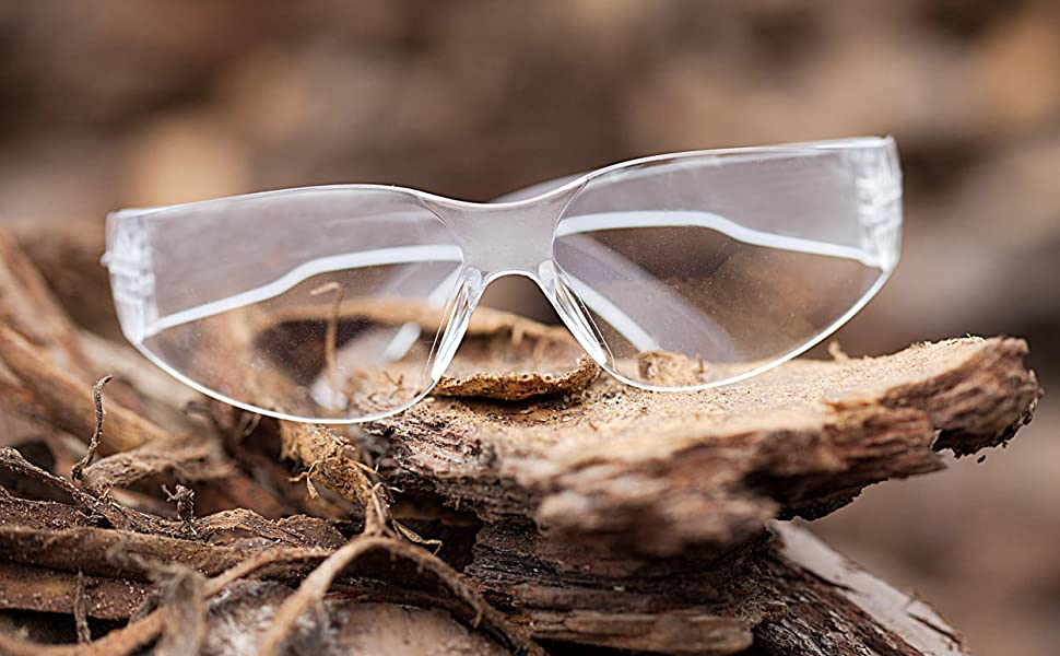 Image of clear lens clear temple safety glasses up close outdoors.