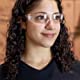 Image of woman wearing clear safety glasses in a warehouse.
