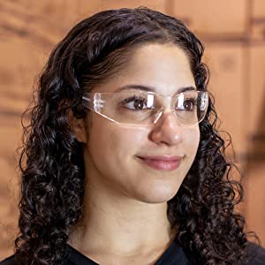 Image of woman wearing clear safety glasses in a warehouse.
