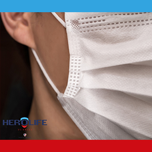 Close up image of side of disposable mask, HeroLife Sciences logo